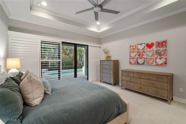 carpeted bedroom featuring access to outside, a raised ceiling, ceiling fan, and crown molding