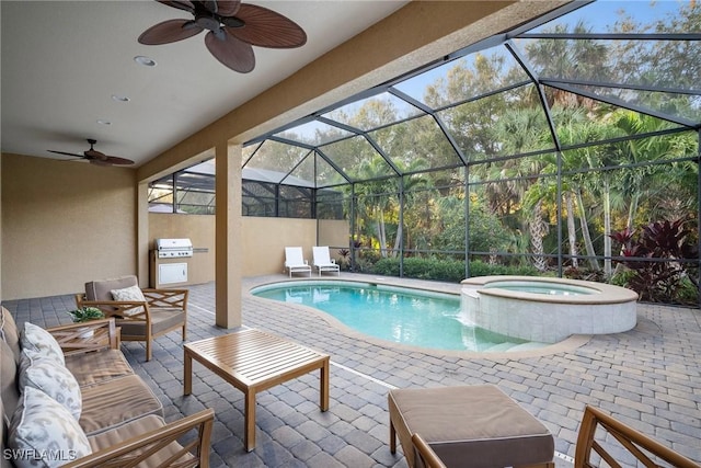 view of pool with outdoor lounge area, glass enclosure, ceiling fan, an in ground hot tub, and a patio area