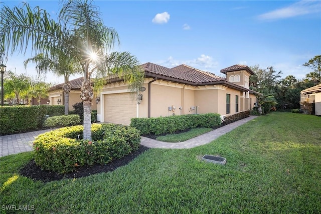 6589 Roma Way, Naples, FL 34113 - view of side of home featuring a tile roof, an attached garage, stucco siding, and a yard