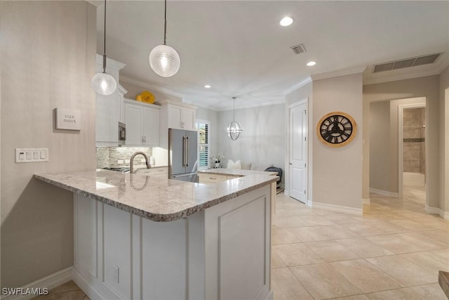 kitchen featuring kitchen peninsula, white cabinetry, hanging light fixtures, and appliances with stainless steel finishes