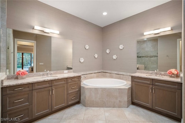 bathroom with shower with separate bathtub, vanity, and tile patterned floors