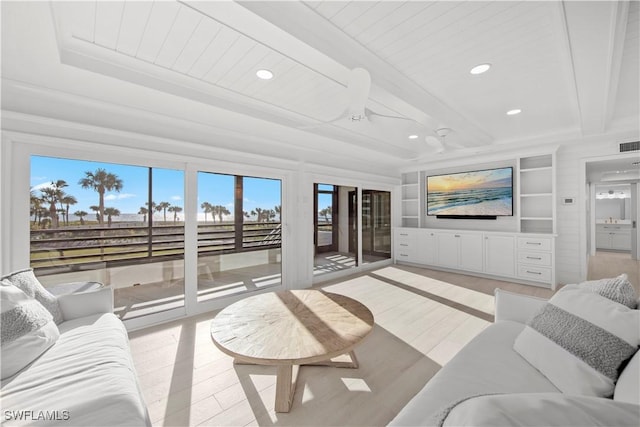 living room with beamed ceiling, built in shelves, light hardwood / wood-style flooring, and wooden ceiling