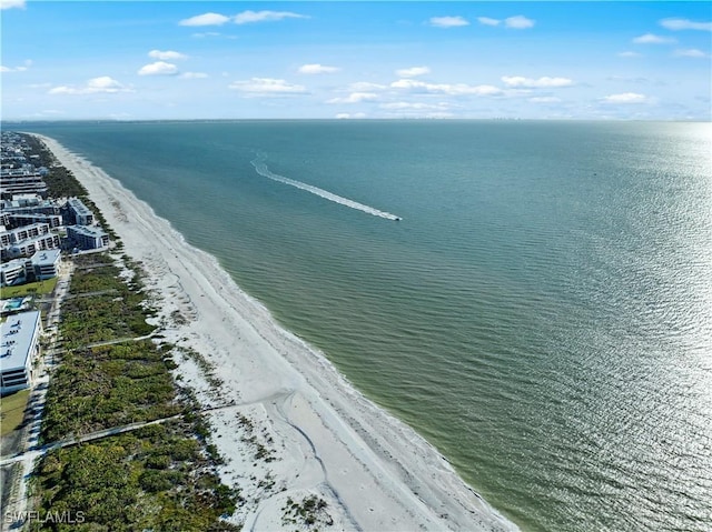 drone / aerial view featuring a water view and a beach view