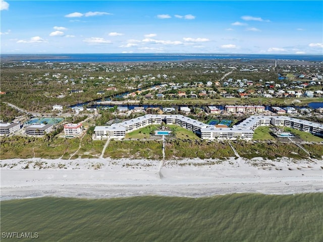 drone / aerial view featuring a beach view and a water view