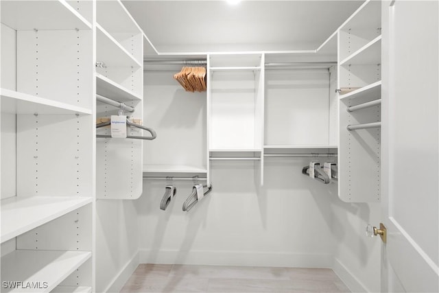 walk in closet with wood-type flooring