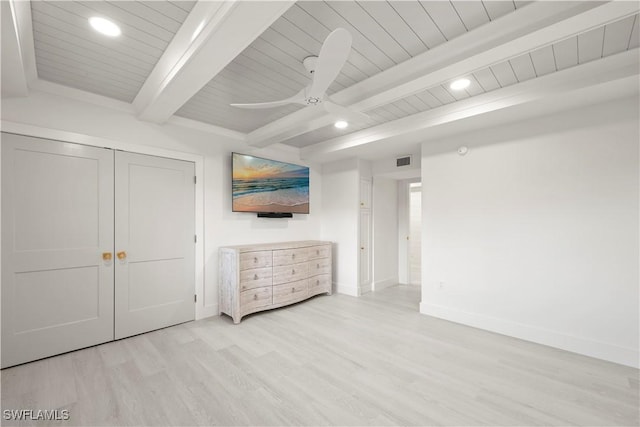 unfurnished bedroom featuring beam ceiling, a closet, ceiling fan, and light hardwood / wood-style flooring