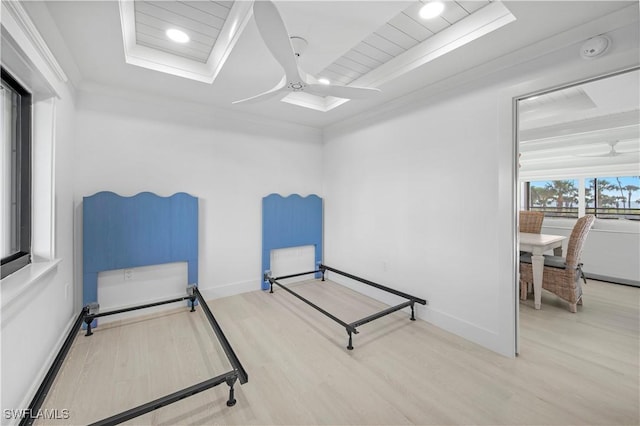 bedroom featuring ceiling fan, crown molding, and light hardwood / wood-style floors