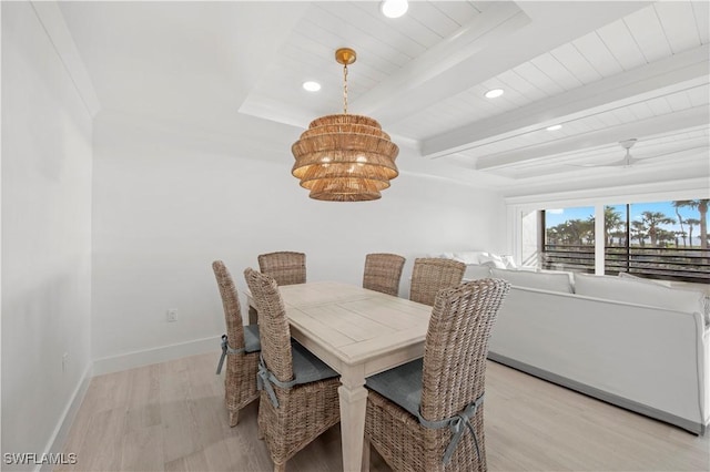 dining space featuring light hardwood / wood-style flooring and beamed ceiling