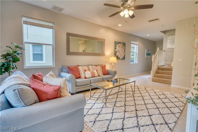 living room featuring ceiling fan and light tile patterned floors