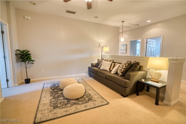 carpeted living room with ceiling fan