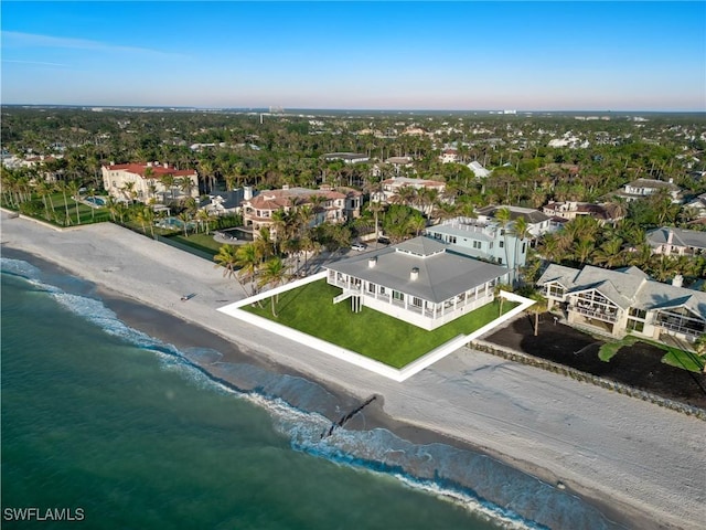 birds eye view of property with a water view and a view of the beach