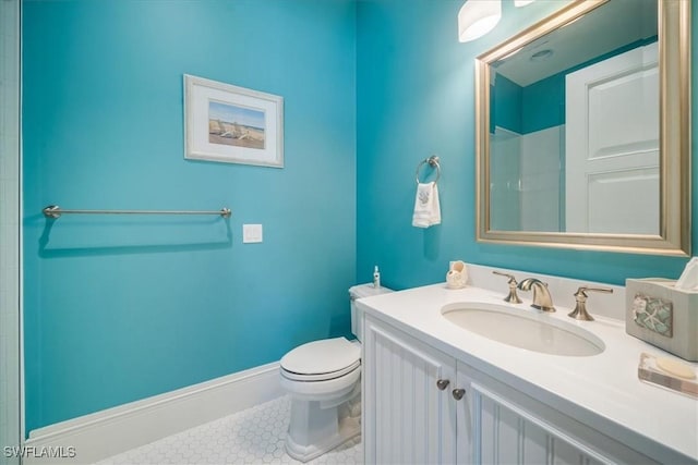 bathroom featuring tile patterned flooring, vanity, and toilet