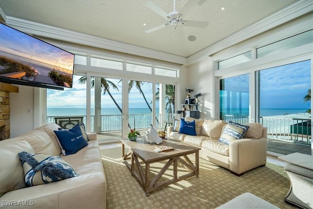 sunroom with a water view and ceiling fan