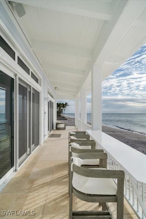 view of patio featuring a water view and a view of the beach