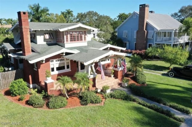 1249 Osceola Dr, Fort Myers, FL 33901 - rear view of property with a chimney and a shingled roof