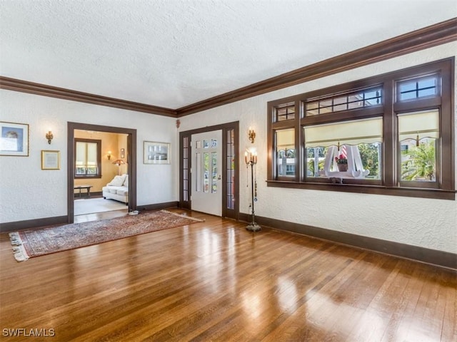 1249 Osceola Dr, Fort Myers, FL 33901 - entrance foyer featuring a textured ceiling, wood finished floors, baseboards, a textured wall, and ornamental molding