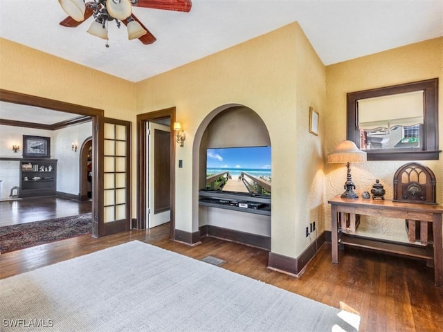 1249 Osceola Dr, Fort Myers, FL 33901 - bedroom with arched walkways, wood finished floors, baseboards, and ceiling fan