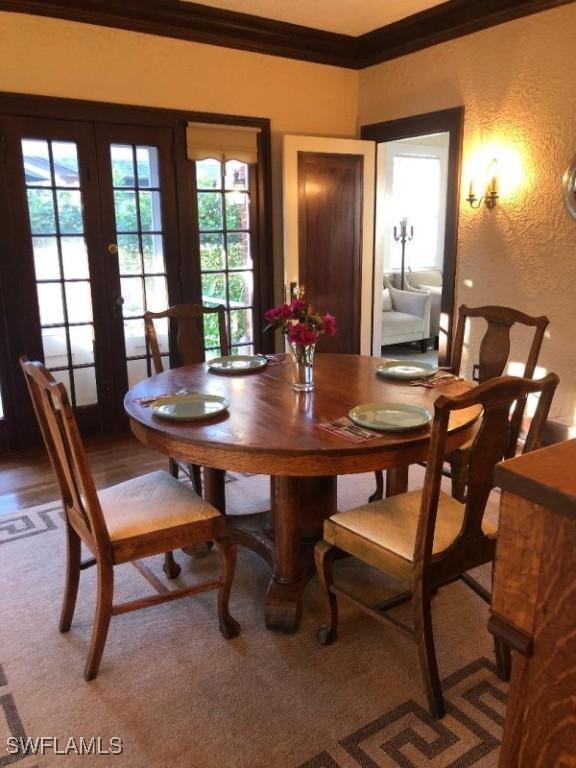 1249 Osceola Dr, Fort Myers, FL 33901 - dining space with crown molding, french doors, and a textured wall