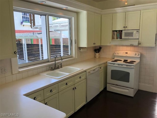 1249 Osceola Dr, Fort Myers, FL 33901 - kitchen featuring white appliances, a sink, light countertops, decorative backsplash, and white cabinets