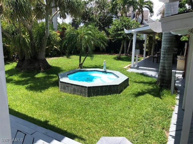 1249 Osceola Dr, Fort Myers, FL 33901 - view of green lawn with an outdoor hot tub and a patio