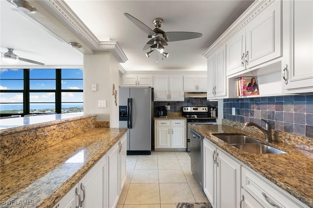 kitchen featuring white cabinets, light tile patterned flooring, sink, and appliances with stainless steel finishes