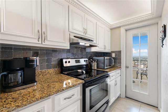 kitchen with backsplash, dark stone counters, white cabinets, light tile patterned floors, and appliances with stainless steel finishes