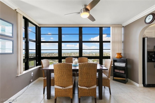 dining room featuring floor to ceiling windows, ceiling fan, light tile patterned flooring, and ornamental molding