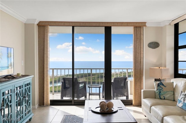 tiled living room featuring a healthy amount of sunlight, a water view, and crown molding