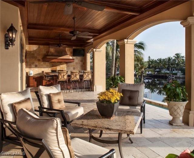 view of patio / terrace featuring ceiling fan and a bar