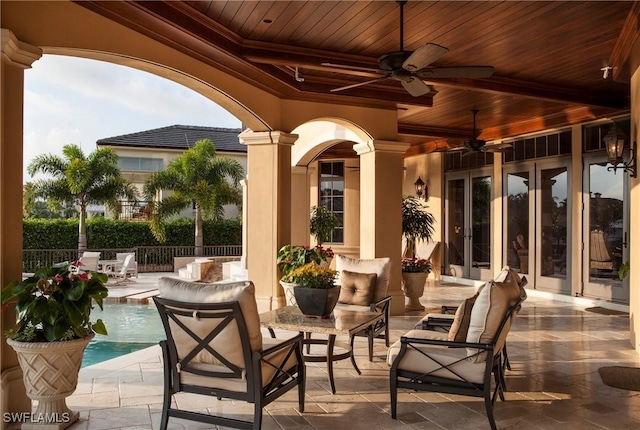 view of patio / terrace with ceiling fan and a fenced in pool