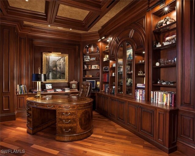 interior space featuring beam ceiling, ornamental molding, coffered ceiling, and hardwood / wood-style floors