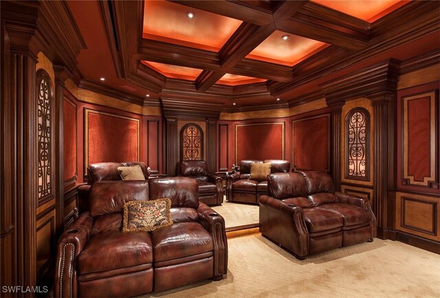 cinema room with wood walls, light colored carpet, ornamental molding, and ornate columns