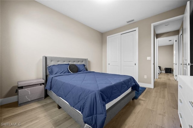 bedroom featuring light wood-type flooring and a closet