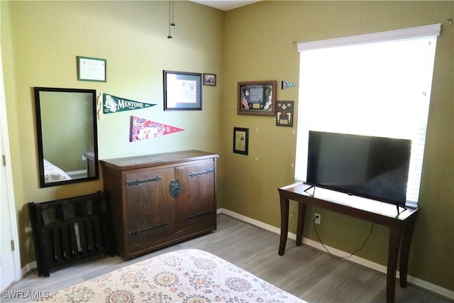 office area featuring radiator heating unit and light wood-type flooring