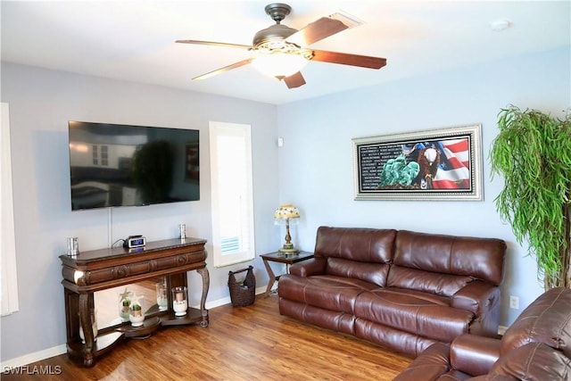 living room featuring hardwood / wood-style flooring and ceiling fan