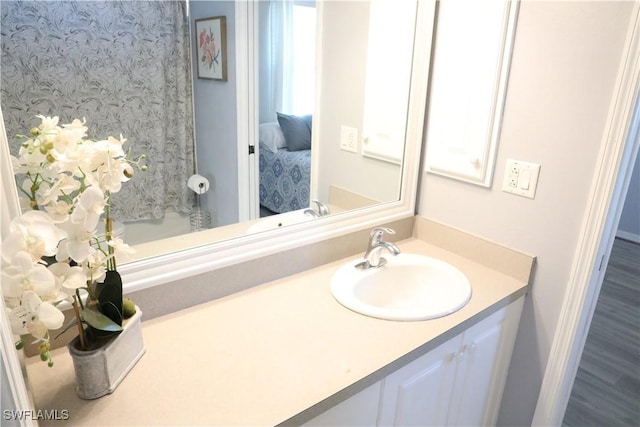 bathroom with vanity and hardwood / wood-style floors