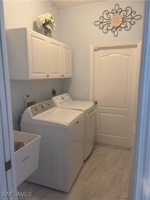 laundry area with sink, cabinets, and washing machine and clothes dryer