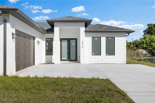 exterior space featuring a garage and a lawn