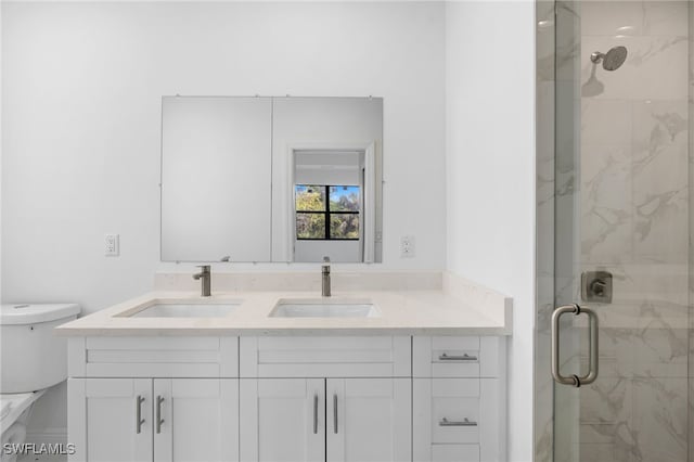 bathroom featuring an enclosed shower, vanity, and toilet