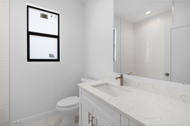 bathroom with toilet and vanity