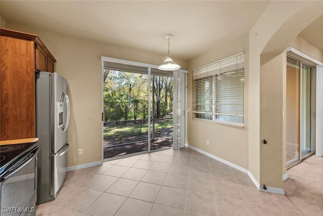 unfurnished dining area featuring light tile patterned floors