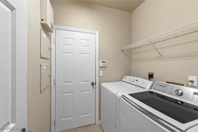 washroom featuring independent washer and dryer and light tile patterned flooring