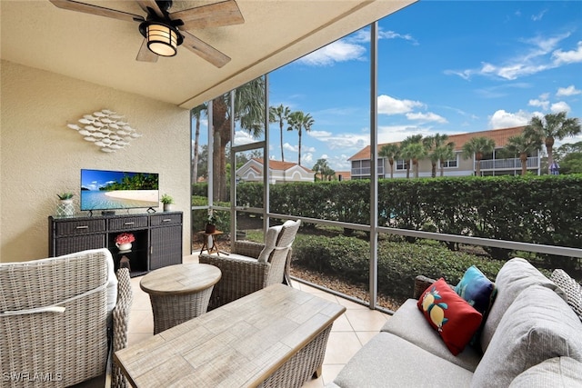 sunroom featuring ceiling fan