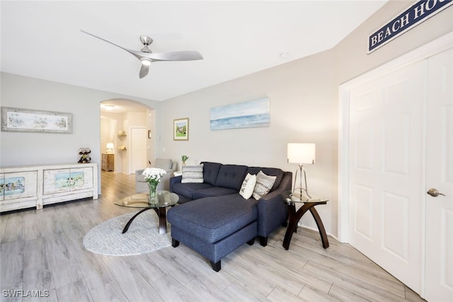 living room with ceiling fan and light hardwood / wood-style floors