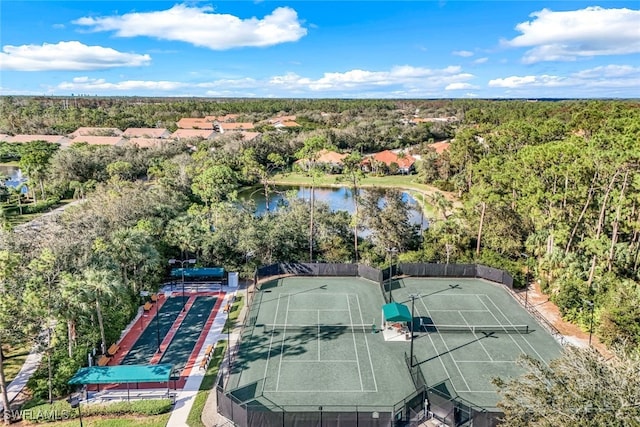 drone / aerial view featuring a forest view and a water view