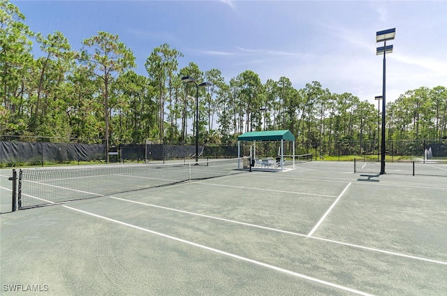 view of tennis court with fence