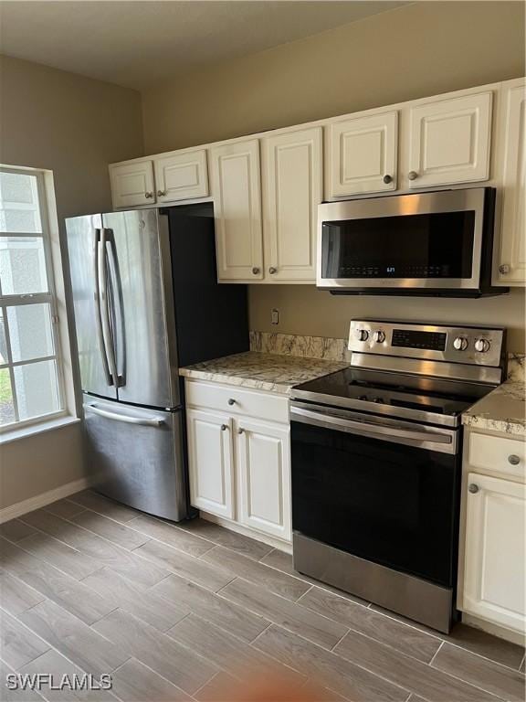 kitchen with white cabinetry and appliances with stainless steel finishes