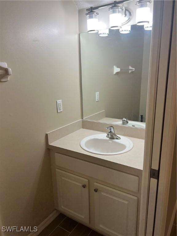 bathroom with tile patterned flooring and vanity