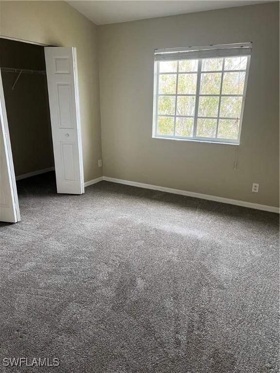 unfurnished bedroom with a closet and carpet floors