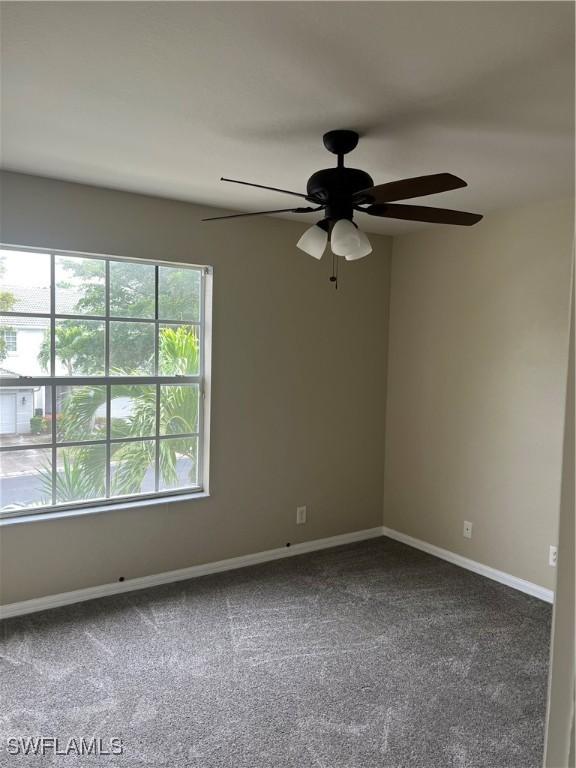 unfurnished room featuring carpet and ceiling fan